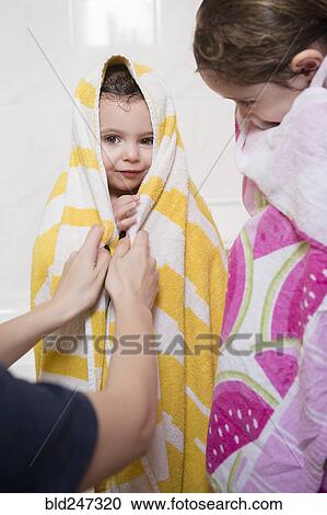 Caucasian mother drying daughters with towels View Large Photo Image Stock Image - Caucasian mother drying daughters with towels. Fotosearch