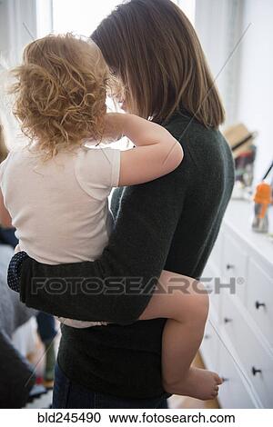 Caucasian mother holding daughter View Large Photo Image Stock Image - Caucasian mother holding daughter. Fotosearch