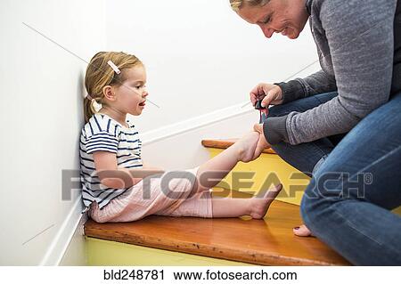 Caucasian mother painting toenails of daughter on staircase View Large Photo Image Stock Image - Caucasian mother painting toenails of daughter on staircase. Fotosearch