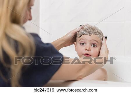 Caucasian mother washing hair of girl in bathtub View Large Photo Image Stock Photograph - Caucasian mother washing hair of girl in bathtub. Fotosearch