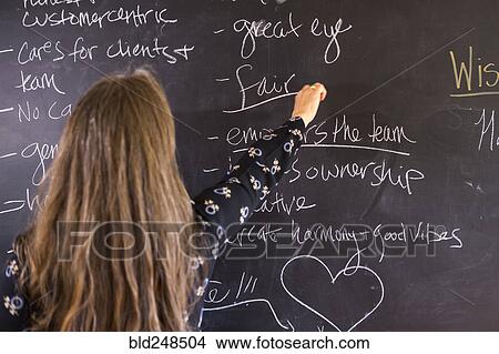 Caucasian teacher underlining fair on blackboard View Large Photo Image Picture - Caucasian teacher underlining fair on blackboard. Fotosearch