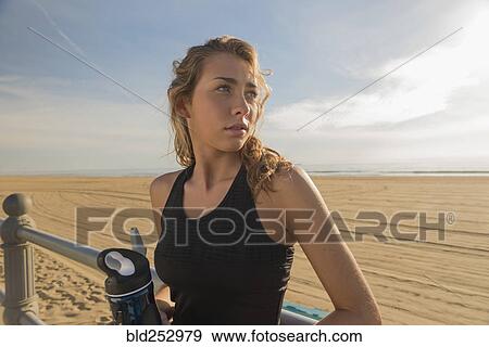 Caucasian teenage girl leaning on railing at beach View Large Photo Image Stock Photo - Caucasian teenage girl leaning on railing at beach. Fotosearch