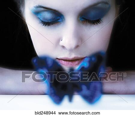 Picture - Caucasian teenage girl resting near blue butterfly. Fotosearch