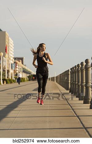 Caucasian teenage girl running on boardwalk View Large Photo Image Picture - Caucasian teenage girl running on boardwalk. Fotosearch
