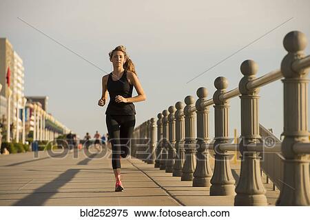 Caucasian teenage girl running on boardwalk View Large Photo Image Stock Photography - Caucasian teenage girl running on boardwalk. Fotosearch