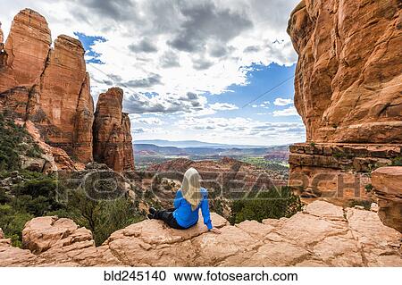 Stock Image - Caucasian woman admiring scenic view in desert landscape. Fotosearch