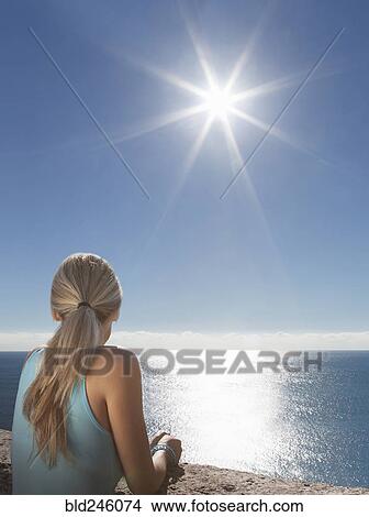 Picture - Caucasian woman admiring scenic view of ocean. Fotosearch