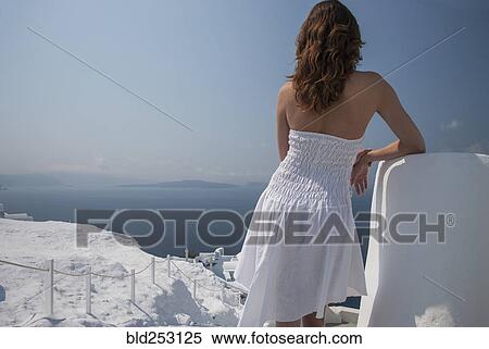 Stock Photography - Caucasian woman admiring scenic view of ocean. Fotosearch