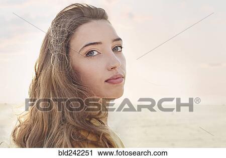 Stock Image - Caucasian woman at beach. Fotosearch