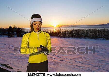 Caucasian woman checking the time on wristwatch in winter View Large Photo Image Stock Photography - Caucasian woman checking the time on wristwatch in winter. Fotosearch