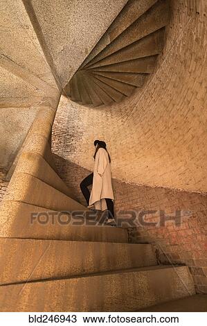 Stock Image - Caucasian woman climbing stone staircase. Fotosearch