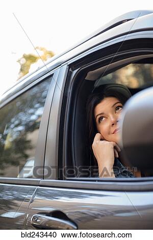 Caucasian woman daydreaming in car View Large Photo Image Stock Image - Caucasian woman daydreaming in car. Fotosearch