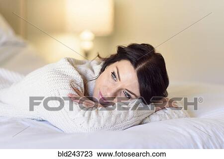 Caucasian woman daydreaming on bed View Large Photo Image Stock Image - Caucasian woman daydreaming on bed. Fotosearch