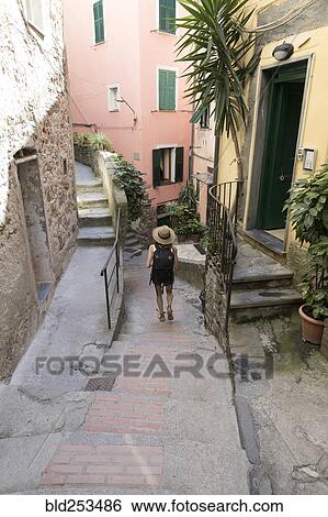 Stock Photograph - Caucasian woman descending outdoors staircase. Fotosearch