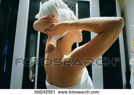 Stock Image - Caucasian woman drying hair with towel. Fotosearch