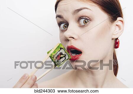 Caucasian woman eating sushi with chopsticks View Large Photo Image Stock Image - Caucasian woman eating sushi with chopsticks. Fotosearch
