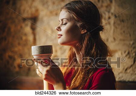 Caucasian woman enjoying aroma of cup of tea View Large Photo Image Stock Photograph - Caucasian woman enjoying aroma of cup of tea. Fotosearch