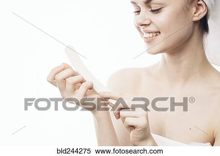 Caucasian woman filing nails View Large Photo Image Stock Photography - Caucasian woman filing nails. Fotosearch