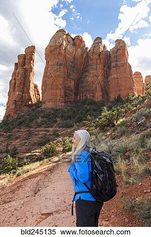 Stock Photography - Caucasian woman hiking in desert landscape. Fotosearch