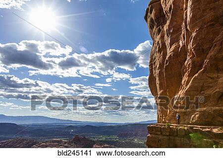Caucasian woman hiking on ledge of cliff View Large Photo Image Stock Image - Caucasian woman hiking on ledge of cliff. Fotosearch