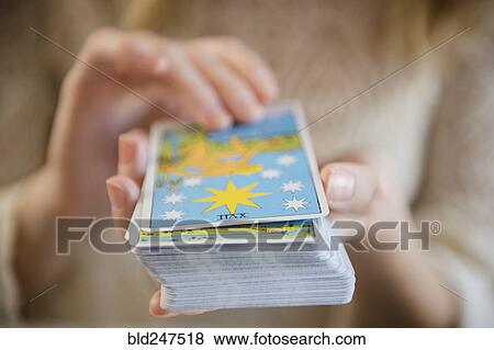 Caucasian woman holding a deck of tarot cards View Large Photo Image Stock Photo - Caucasian woman holding a deck of tarot cards. Fotosearch