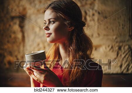 Stock Photo - Caucasian woman holding cup of tea. Fotosearch