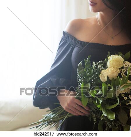 Stock Photo - Caucasian woman holding roses. Fotosearch