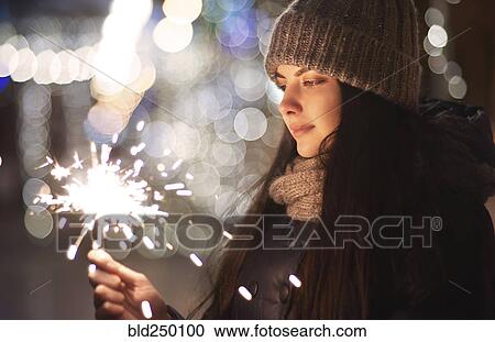 Caucasian woman holding sparkler View Large Photo Image Stock Image - Caucasian woman holding sparkler. Fotosearch