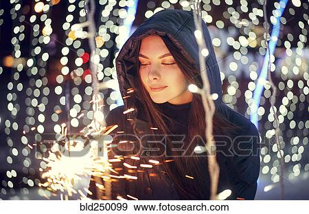 Caucasian woman holding sparkler View Large Photo Image Stock Photo - Caucasian woman holding sparkler. Fotosearch