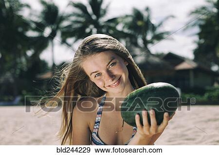 Caucasian woman holding watermelon on beach View Large Photo Image Stock Photo - Caucasian woman holding watermelon on beach. Fotosearch