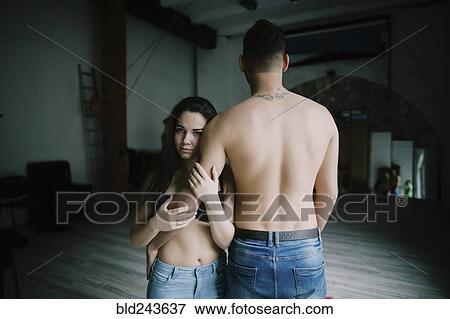 Caucasian woman hugging arm of man with bare back View Large Photo Image Stock Photo - Caucasian woman hugging arm of man with bare back. Fotosearch