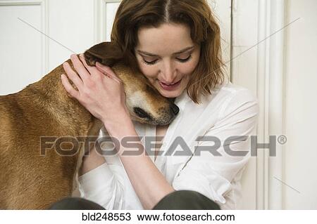 Caucasian woman hugging dog View Large Photo Image Stock Image - Caucasian woman hugging dog. Fotosearch