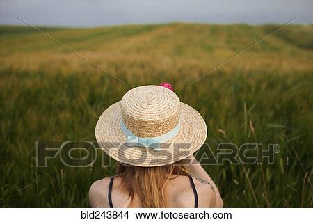 Picture - Caucasian woman in field of tall grass. Fotosearch