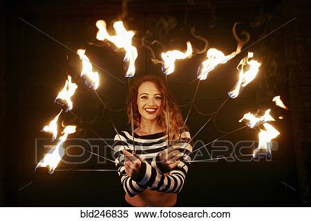 Caucasian woman juggling fire at night View Large Photo Image Stock Photography - Caucasian woman juggling fire at night. Fotosearch