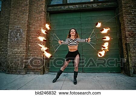 Caucasian woman juggling fire on city sidewalk View Large Photo Image Stock Image - Caucasian woman juggling fire on city sidewalk. Fotosearch