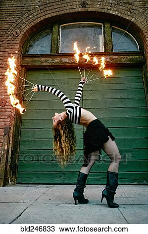 Caucasian woman juggling fire on city sidewalk View Large Photo Image Stock Image - Caucasian woman juggling fire on city sidewalk. Fotosearch