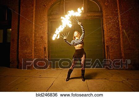 Caucasian woman juggling fire on city sidewalk at night View Large Photo Image Stock Photograph - Caucasian woman juggling fire on city sidewalk at night. Fotosearch