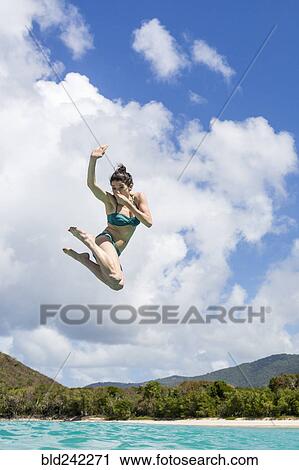 Caucasian woman jumping into tropical ocean View Large Photo Image Stock Image - Caucasian woman jumping into tropical ocean. Fotosearch