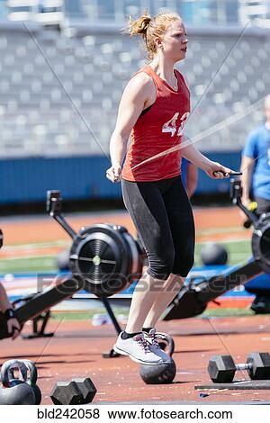 Stock Photo - Caucasian woman jumping rope outdoors. Fotosearch