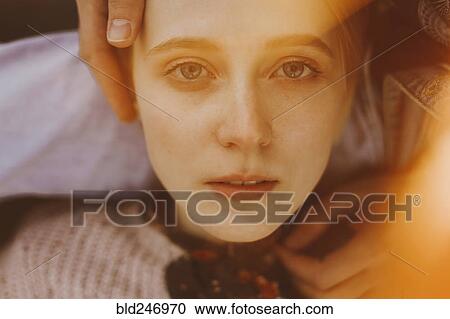 Stock Image - Caucasian woman laying in lap of man. Fotosearch
