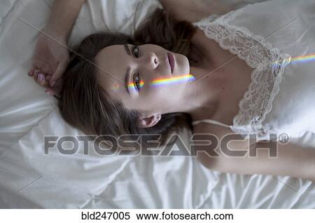 Caucasian woman laying on bed wearing nightgown View Large Photo Image Stock Photography - Caucasian woman laying on bed wearing nightgown. Fotosearch