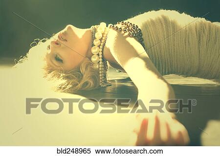 Caucasian woman laying on sunny floor View Large Photo Image Stock Photography - Caucasian woman laying on sunny floor. Fotosearch