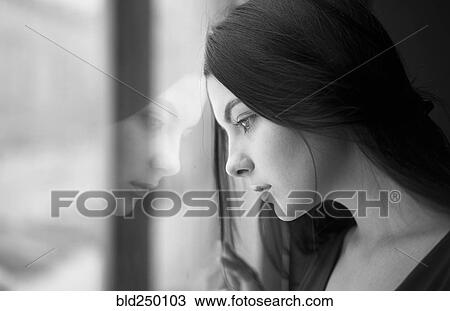 Caucasian woman leaning forehead on window View Large Photo Image Stock Image - Caucasian woman leaning forehead on window. Fotosearch