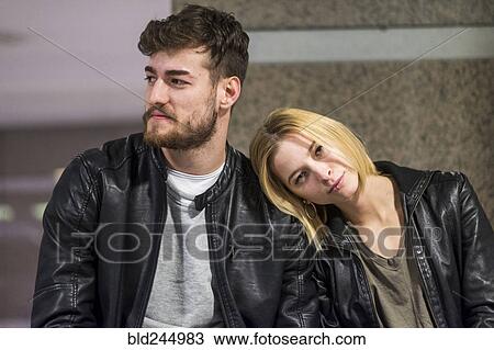 Stock Image - Caucasian woman leaning head on shoulder of man. Fotosearch