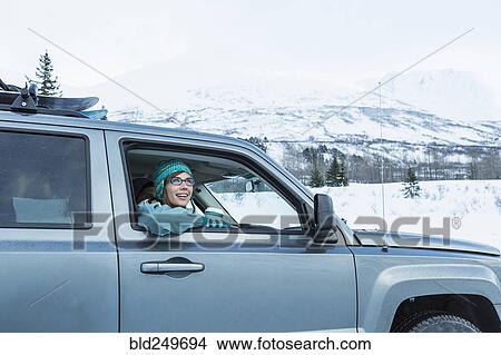 Caucasian woman leaning in car window in winter View Large Photo Image Picture - Caucasian woman leaning in car window in winter. Fotosearch