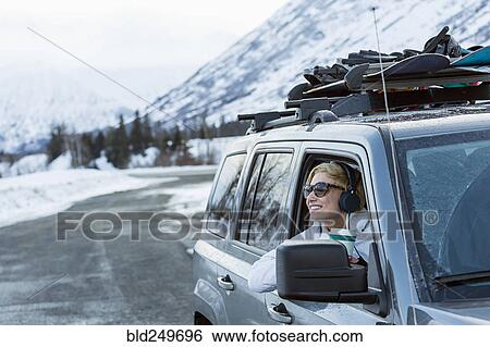 Caucasian woman leaning in car window in winter View Large Photo Image Stock Photograph - Caucasian woman leaning in car window in winter. Fotosearch