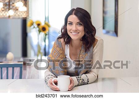 Caucasian woman leaning on counter drinking coffee View Large Photo Image Stock Image - Caucasian woman leaning on counter drinking coffee. Fotosearch