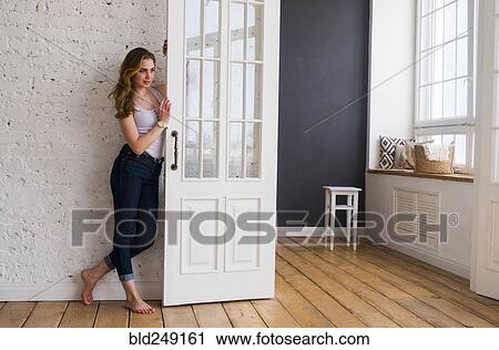 Caucasian woman leaning on door View Large Photo Image Stock Image - Caucasian woman leaning on door. Fotosearch