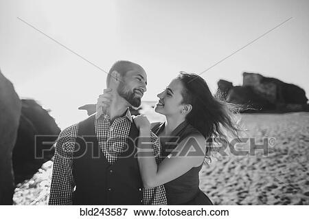 Stock Photo - Caucasian woman leaning on man at beach. Fotosearch
