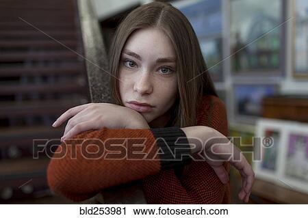 Caucasian woman leaning on staircase railing View Large Photo Image Stock Image - Caucasian woman leaning on staircase railing. Fotosearch